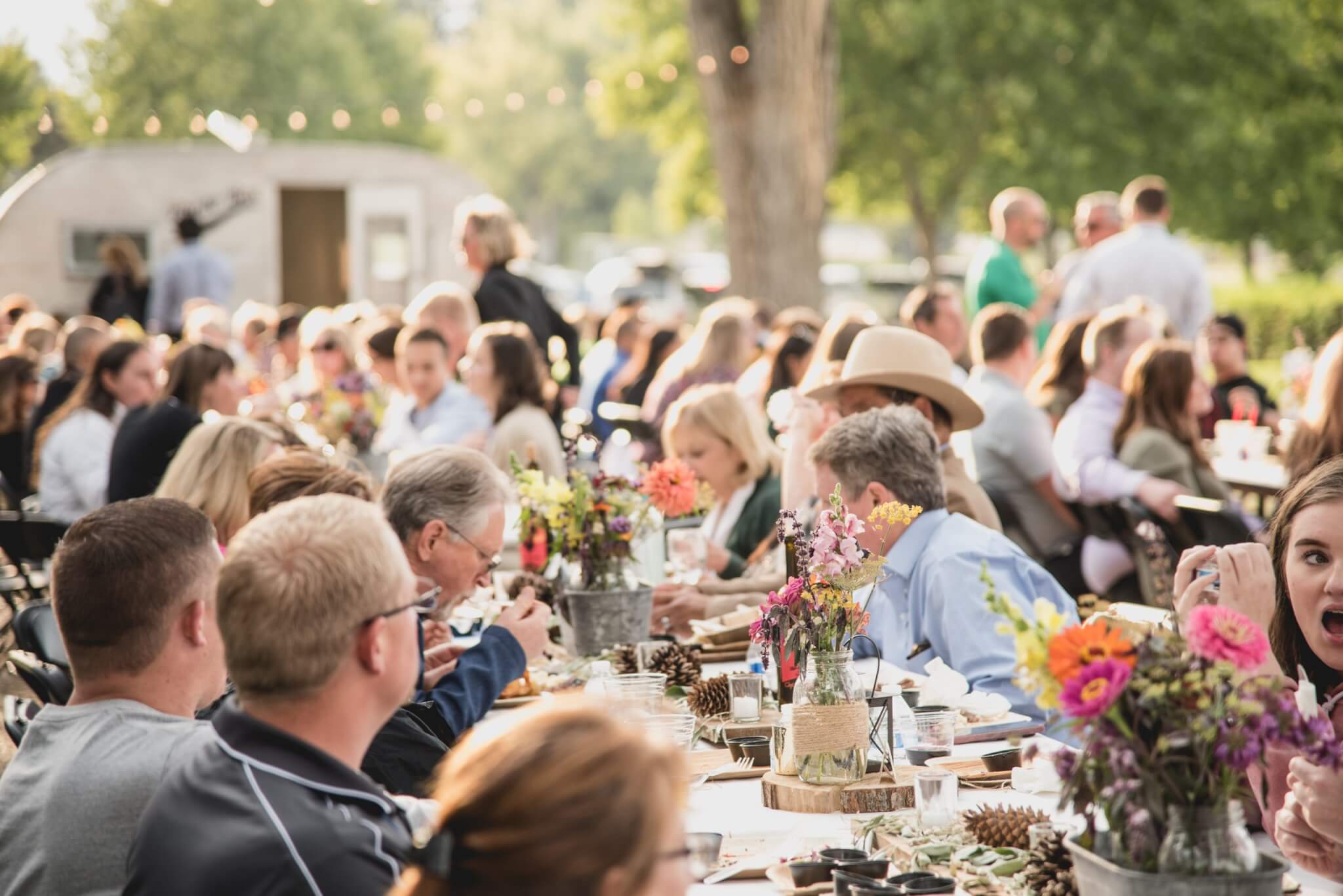 A group of people eating together at a communal table.