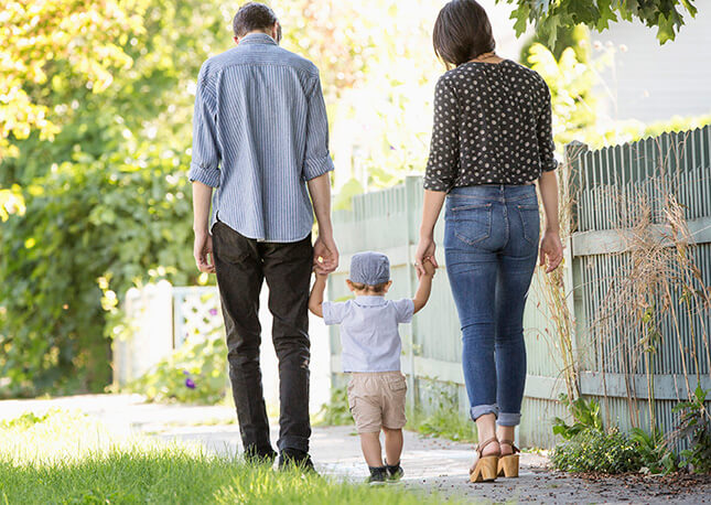 Two parents and a child walking in Nampa, Idaho.